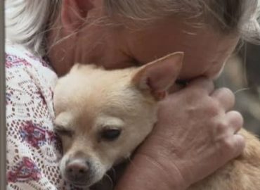 CNBC_LISA HUGGING DOG